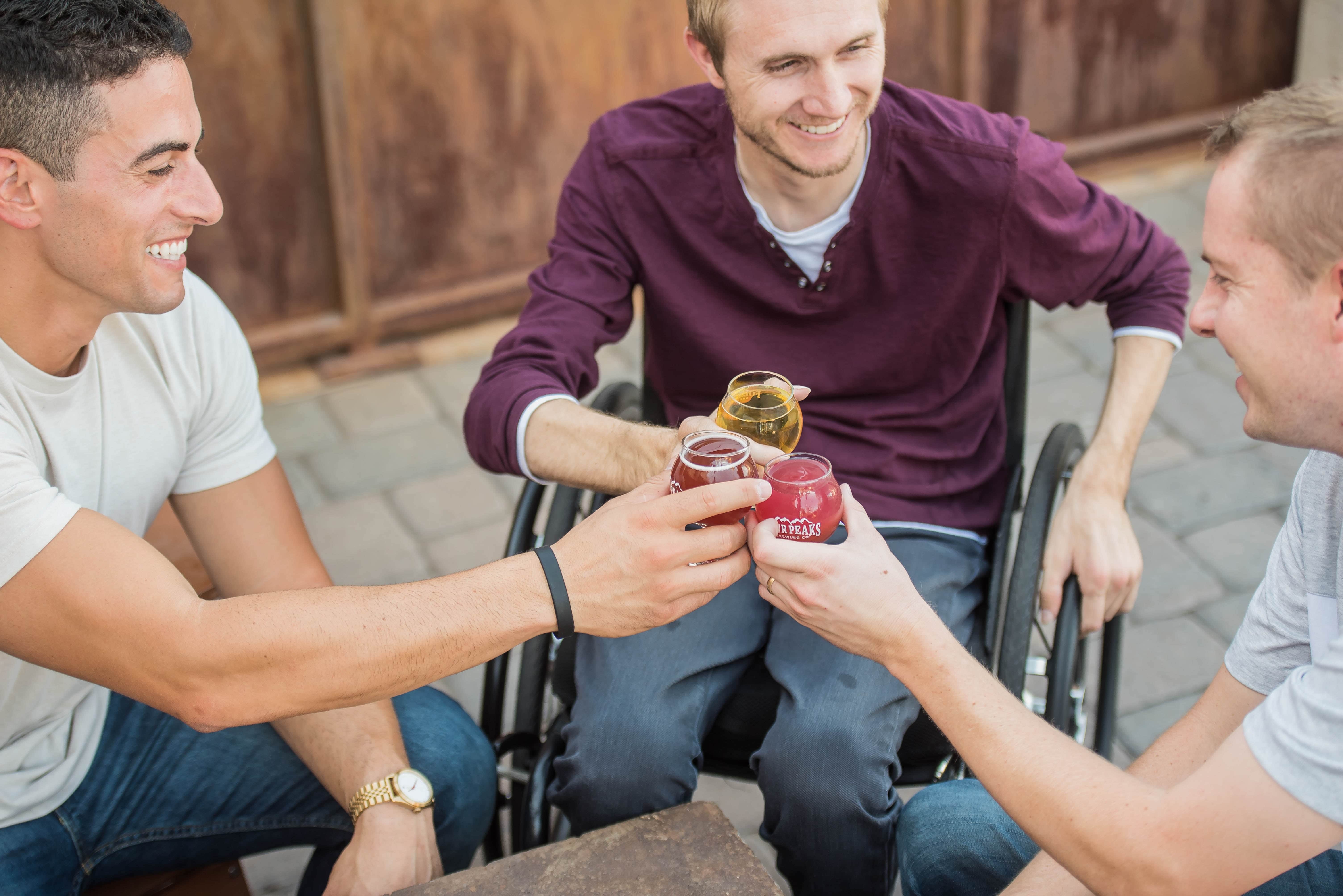 Man in wheel chair socialising with friends